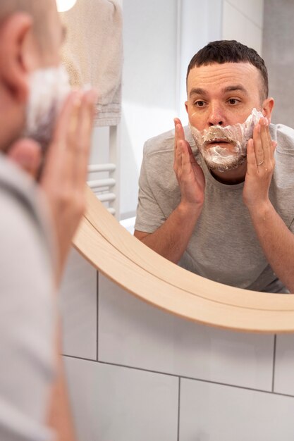 Dad teaching his son how to shave