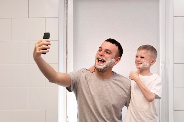 Dad teaching his son how to shave