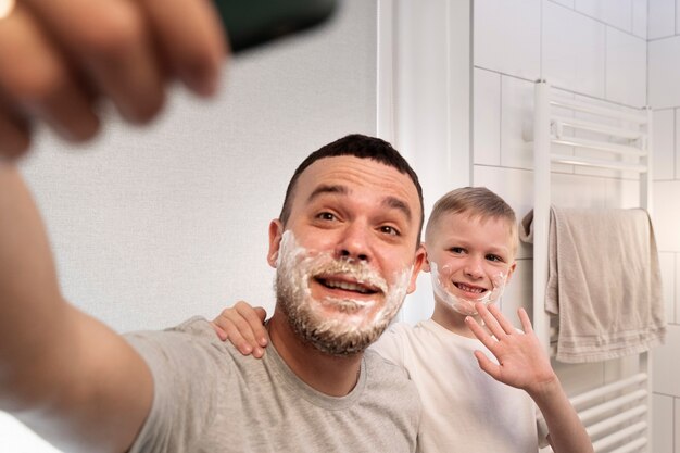 Dad teaching his son how to shave