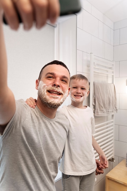 Dad teaching his son how to shave