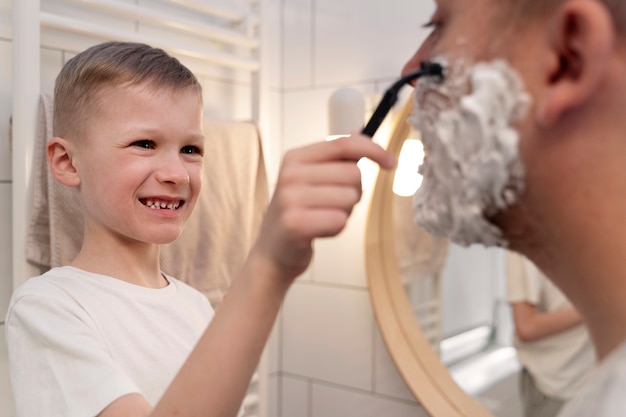 Dad teaching his son how to shave