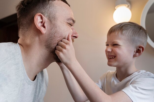 Dad teaching his son how to shave