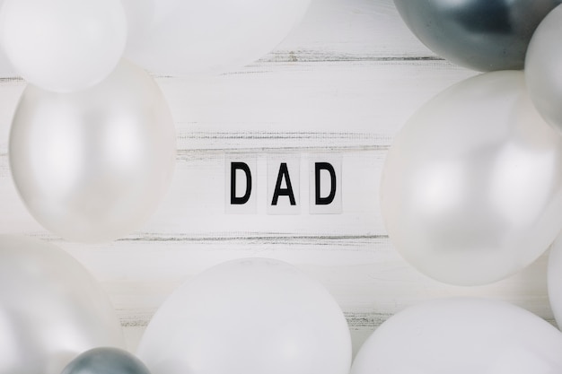 Dad title between balloons