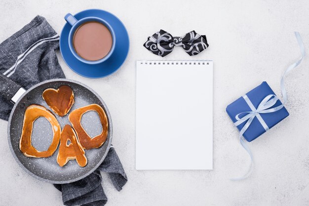 Dad word written in bread buns and gifts