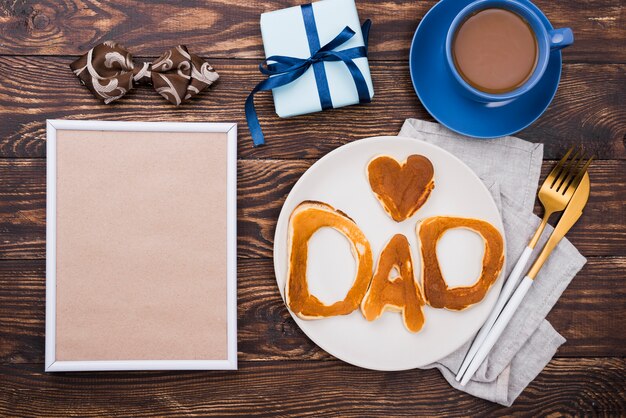 Dad word written in bread buns on plate