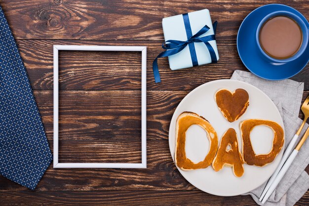 Dad word written in bread buns  and wooden board