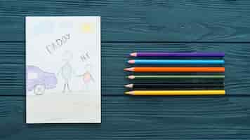 Free photo daddy and me inscription with colorful pencils