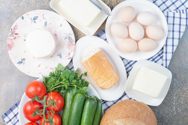 Dairy products, bread and vegetables for breakfast.