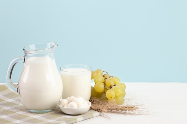 Dairy products and grapes on table