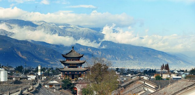 Dali old town rooftop view with cloudy Mt Cangshan. Yunnan, China.