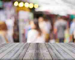 Free photo damaged boards with unfocused people background