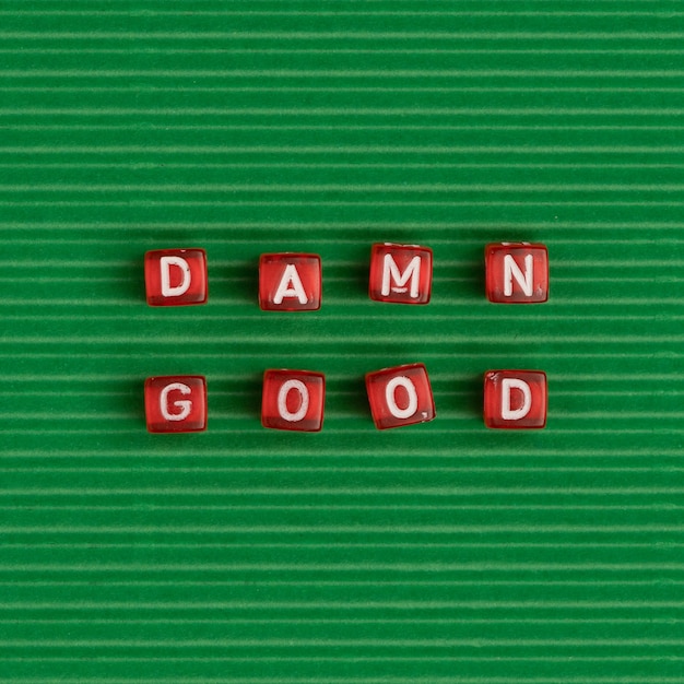 Free photo damn good beads word typography on green