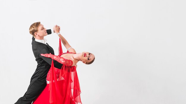 Dance partners waltzing on white background