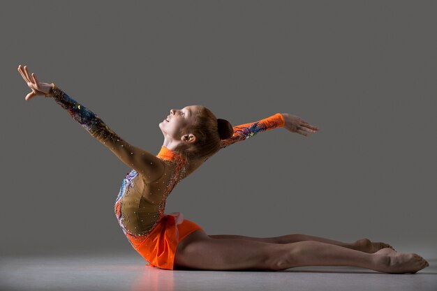 Dancer girl doing backbend gymnastics exercise