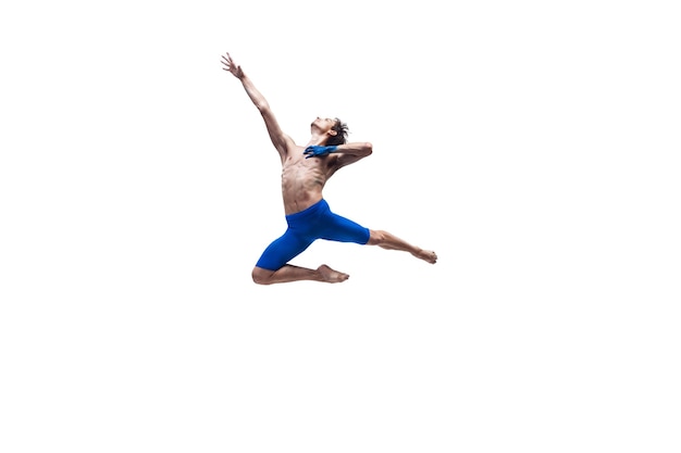Dancer man in blue clothes dancing in the studio