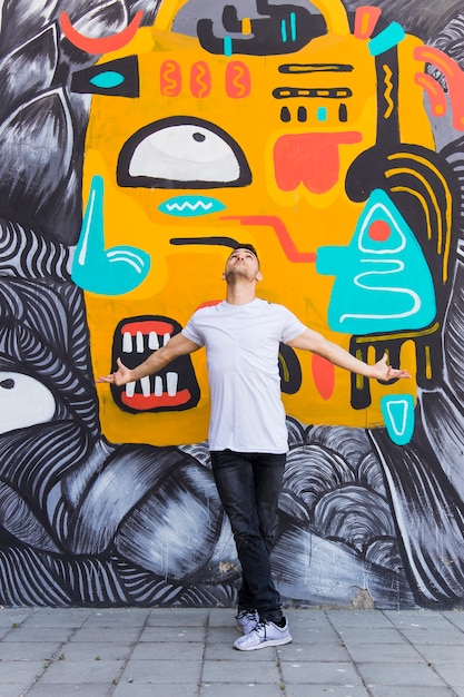 Dancer posing in front of graffiti wall