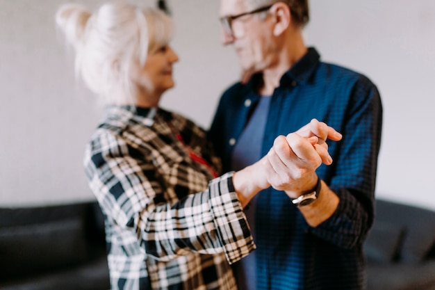 Dancing elderly couple in retirement home