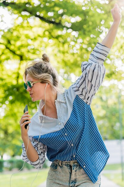 Dancing in the park and listening to music front view