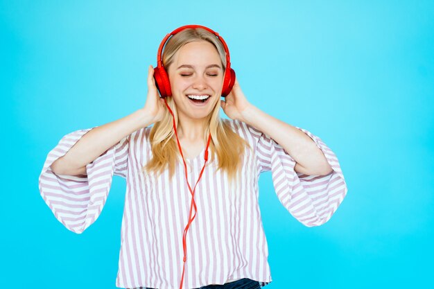 Dancing woman listens to music in headphones