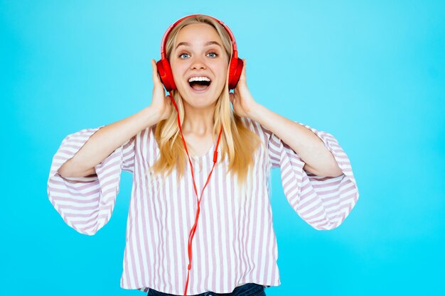 Dancing woman listens to music in headphones