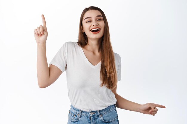 Dancing woman points sideways at two ways showing advertisement choices up and right promo deal indicate at banner standing over white background