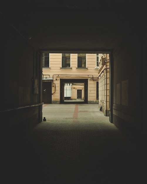 dark archway with a building visible in the background