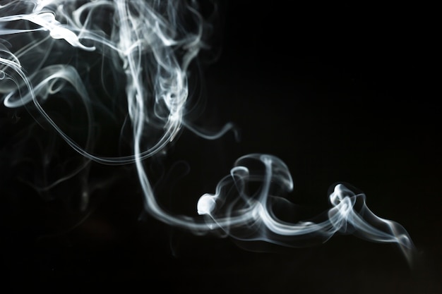 Dark background with delicate wavy smoke