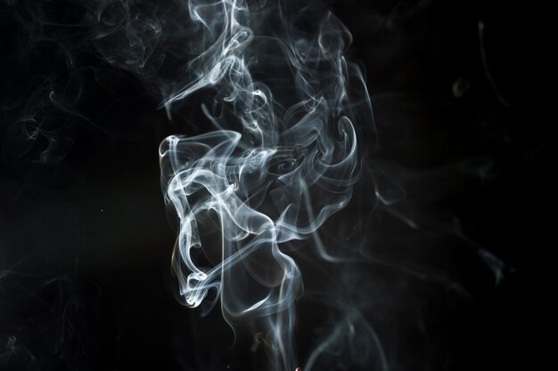 Dark background with delicate white smoke