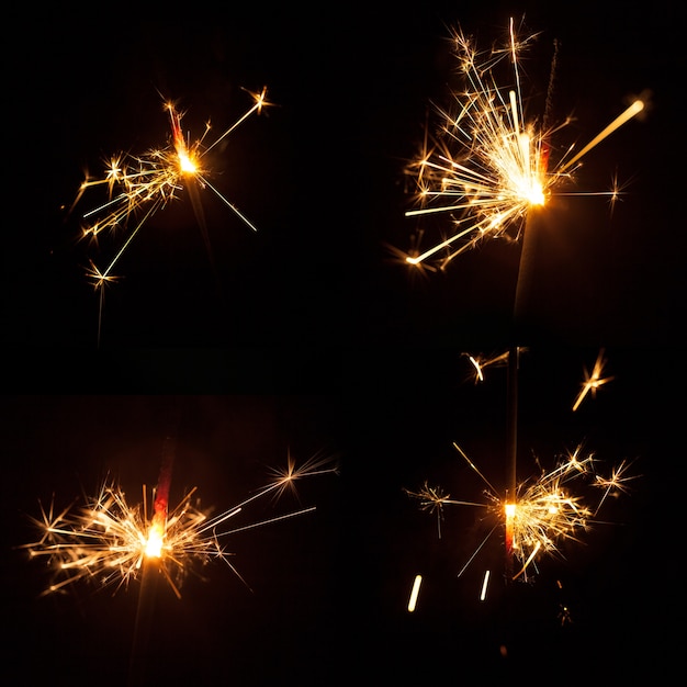 Free photo dark background with four bright sparklers