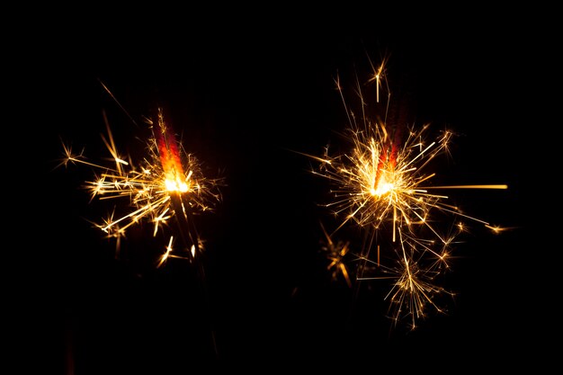 Dark background with two sparklers