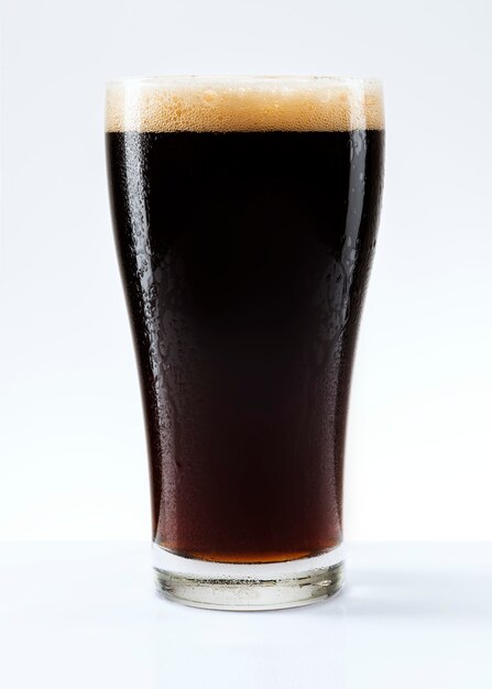 Dark beer with foam in a pint