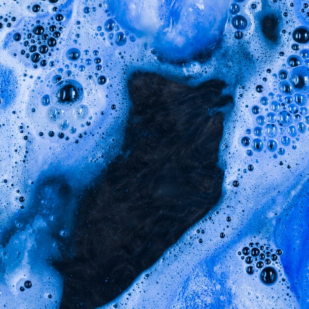 Dark blue liquid with light foam