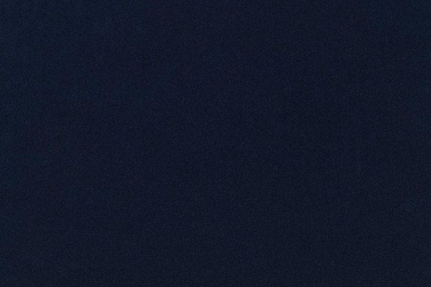 Темно-синий однотонный текстурированный фон с принтами на ткани