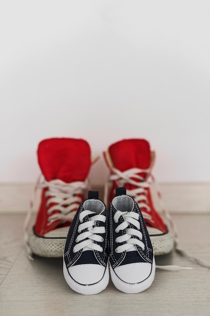 Dark blue shoes with blurred red shoes background