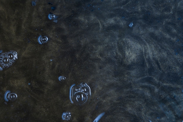 Dark blue water with bubbles