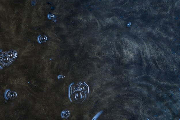 Dark blue water with bubbles