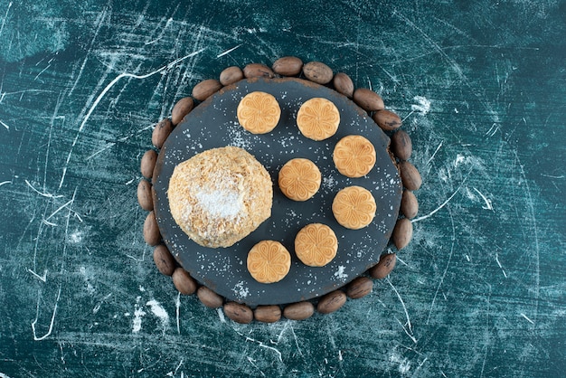 A dark board with cake and cookies on a colorful background. High quality photo