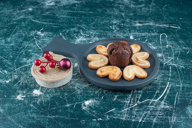 초콜릿 머핀과 쿠키가 있는 다크 보드. 고품질 사진