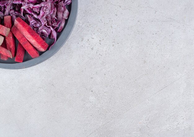 A dark board with sliced cabbage and beetroot. High quality photo