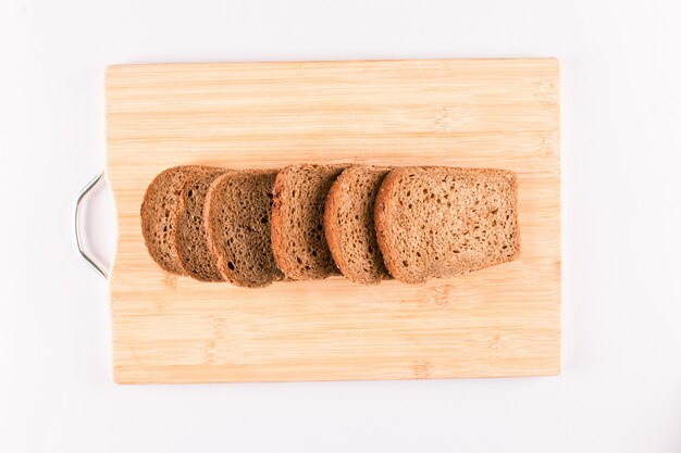 Dark bread slices on a wooden board isolated