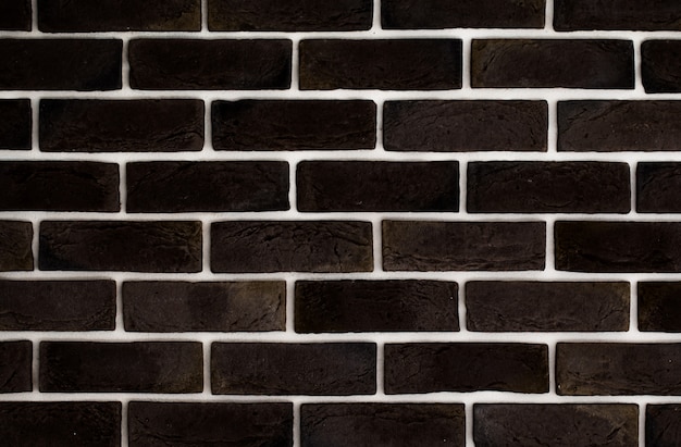 Free photo dark brown brick wall, creative back-phonon, closeup