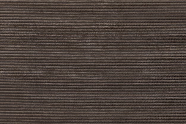 Dark brown corduroy fabric textured background