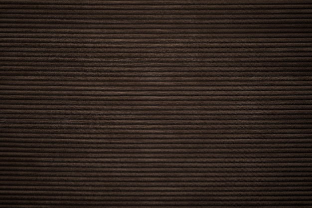 Dark brown corduroy fabric textured background