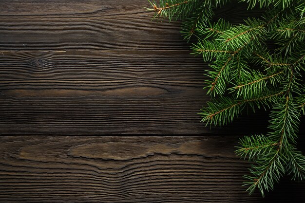 Dark brown wood table with pine beside