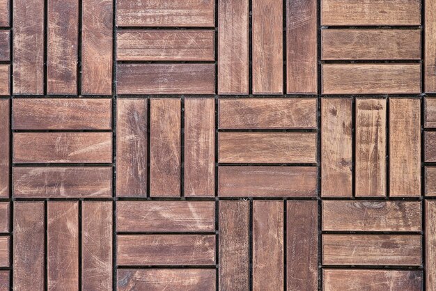 Dark brown wooden floor background from wood bars recycling and second life of products top view