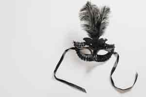 Free photo dark carnival mask with feather on table