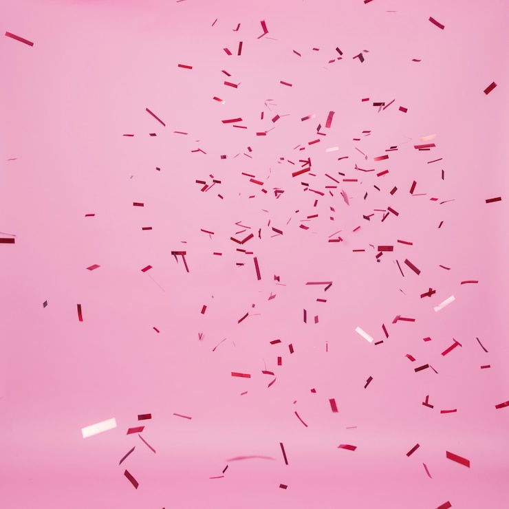 Free Photo dark confetti falling on pink background