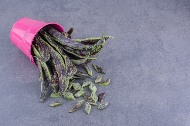 Dark green beans isolated on blue surface