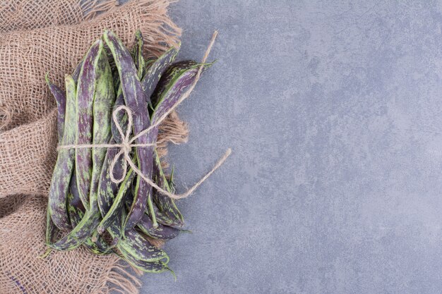 Dark green beans isolated on blue surface