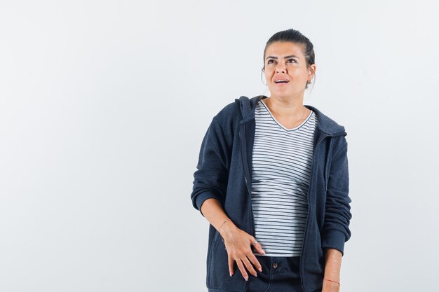 Dark-haired woman looking away in shirt